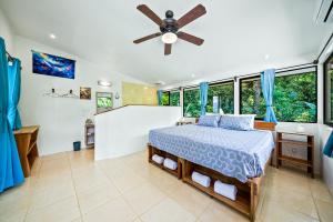 a bedroom with a bed and a ceiling fan at Ocean View Modern dreamhouse 2 in Pavones