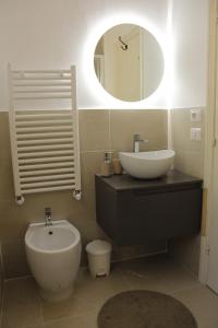 a bathroom with a sink and a toilet and a mirror at DIMORA San Secondo 17D in Gubbio +24 photos