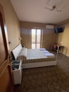 a bedroom with a bed and a window in it at La Ginestra in Santa Maria degli Angeli