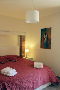 a bedroom with a bed with towels on it at DIMORA San Secondo 17D in Gubbio