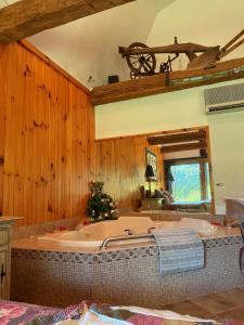 a large bath tub in a room with wooden walls at HIllside Farm B & B in Mount Joy