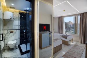 a hotel room with a bathroom with a shower at New dust pyramids hotel in Cairo +78 photos