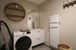 a kitchen with a white refrigerator and a sink at A4 - Résidence La Montille in Mont-Dore +10 photos