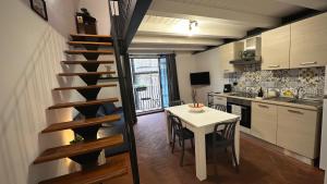 a small kitchen with a table and a spiral staircase at Miralong House in Catania +11 photos
