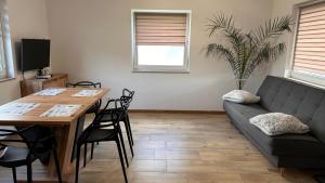 a living room with a couch and a table at Domki całoroczne Jesionowscy - sauna in Kudowa-Zdrój