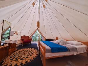 a bedroom with a tent with a bed and a chair at Boutique B&B Agroturizam Sv. Juraj in Krk +39 photos