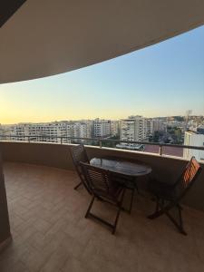 a balcony with a table and chairs and a view of a city at 12valentina in Vlorë