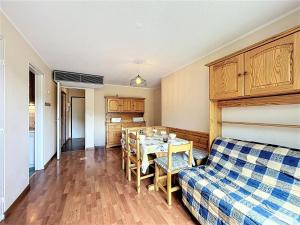 a living room with a table and a couch at Confortable appartement skis aux pieds avec grand balcon - FR-1-267-210 in Villarembert +16 photos