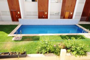 a swimming pool in a yard with some plants at Paradise Javea in Jávea