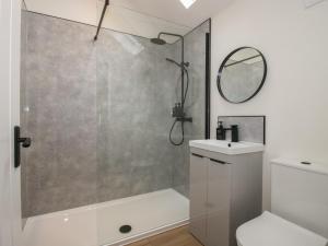 a bathroom with a shower and a toilet and a sink at Oak Barn in Shrewsbury +18 photos