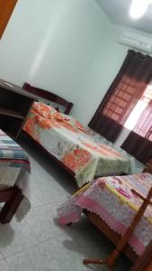 two beds sitting on the floor in a room at Casa de temporada em Aruanã in Aruanã