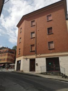 a large brick building on the side of a street at Il Rifugio di Mario in Monzuno