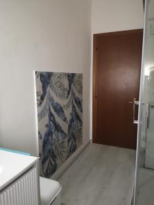 a bathroom with a door and a wall with leaves at Il Rifugio di Mario in Monzuno +37 photos