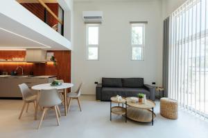 a living room with a couch and a table and chairs at Terra Cielo Kos in Kos