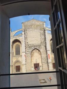 a view of a large stone building from a window at Basil - Vue imprenable sur la Basilique in Saint-Maximin-la-Sainte-Baume