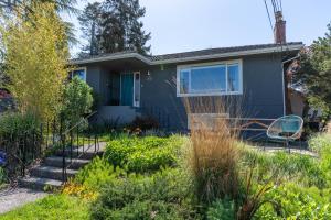 a house with a garden in front of it at Mid-Century Modern Apartment at Horner Park in Victoria