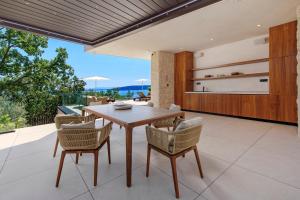 a kitchen and dining room with a table and chairs at Opatija Luxury Villa Ella in Mošćenička Draga