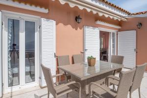 a table and chairs on the patio of a house at Aliki's Residence in Kaminaráta