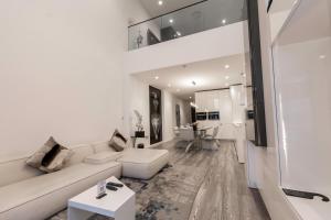 a living room with a white couch and a table at Kwarleyz Residence Hotel & Suites in Accra
