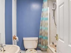 a bathroom with a toilet and a sink and a shower at Apartment 1 Waterrs Edge in Crantock +6 photos