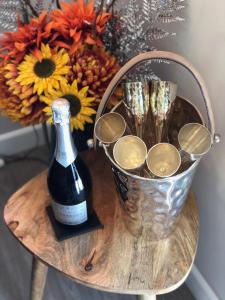 a bottle of wine on a table with a bouquet of flowers at Kites Nest-Qu7488 in Highgate
