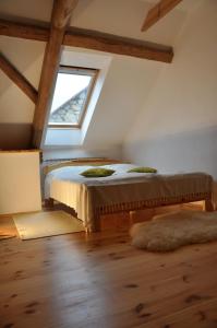 a bedroom with a bed in a attic with a window at Ubytování Česká Kanada in Český Rudolec