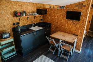 a small kitchen with a sink and a table at The Chard in Carlisle