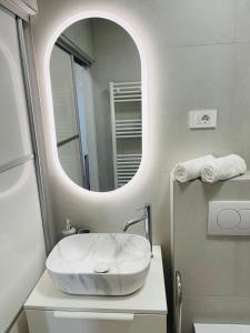 a bathroom with a white sink and a mirror at Villa Tajnikov in Hvar