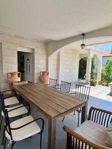 a wooden table and chairs in a patio at Daniela in Vir