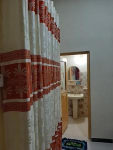 a bathroom with a shower curtain and a sink at Mk yala safari and guest house in Hambantota