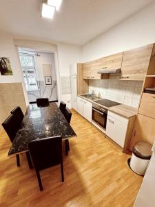 a kitchen with a table and chairs in a room at Lovely Rooms in Märzstraße Area MZ10 in Vienna
