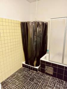 a shower with a black shower curtain in a bathroom at Lovely Rooms in Märzstraße Area MZ10 in Vienna