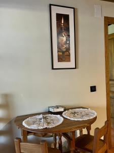 a wooden table with two plates on top of it at Altillo del Aravalle in Umbrías +4 photos