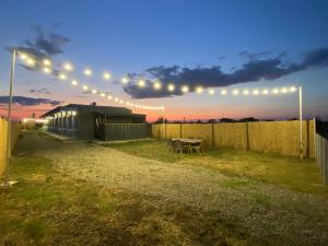 a string of lights over a yard with a picnic table at Sea Side Camping in Vama Veche