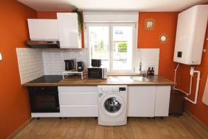 a kitchen with a washing machine and a sink at CDG • Mer de Sable • P.Asterix • Disney • Parking in Saint-Mard
