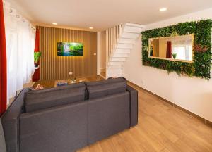 a living room with a couch and a staircase at CDG • Mer de Sable • P.Asterix • Disney • Parking in Saint-Mard