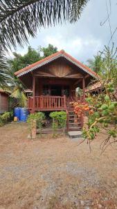 a small house with a porch and a deck at Thai Home Resort in Phra Ae beach
