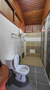 a bathroom with a toilet in a room at Thai Home Resort in Phra Ae beach
