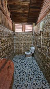 a bathroom with a toilet in a tiled room at Thai Home Resort in Phra Ae beach