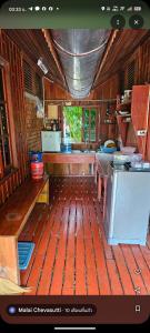 a large kitchen with wooden flooring and a stove at Thai Home Resort in Phra Ae beach