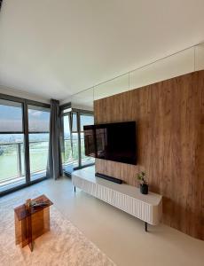a living room with a television on a wall at Eurovea Tower, 27th floor apartment, free parking in Bratislava