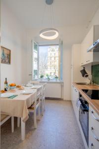 a kitchen and dining room with a table and chairs at Eta - apartman u centru grada in Pula