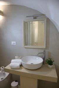 a bathroom with a white sink and a mirror at Casa vacanze La Mescia in Poggiardo +21 photos