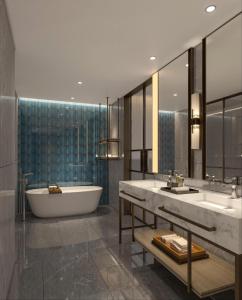 a bathroom with two sinks and a bath tub at Elong Hotel Jakarta PIK in Jakarta +47 photos