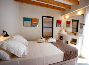 a bedroom with a white bed with two towels on it at MIMARE Dénia in Denia