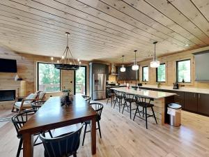a kitchen and living room with a wooden ceiling at Smoky Ridge Sanctuary in Sevierville +38 photos