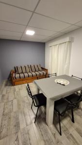 a living room with a table and a couch at Cabañas Gadiel in San José de las Salinas