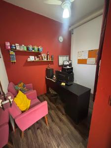 a room with a desk and a chair and a computer at Pousada São Marcos in Santos