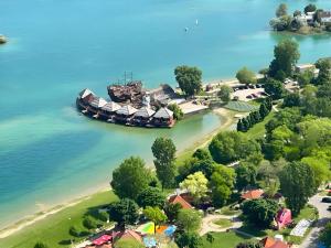 an island in the water next to a beach at Overwater cottage - Slovak Tahiti, Senec in Senec