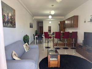 a living room with a couch and a table at Sorrento in St. Julianʼs